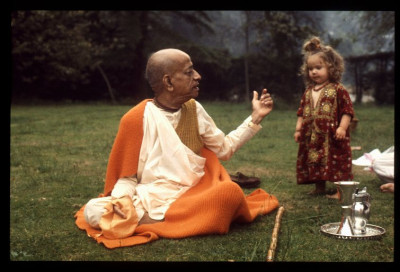 Шрила Прабхупада с ребенком на лужайке в Англии